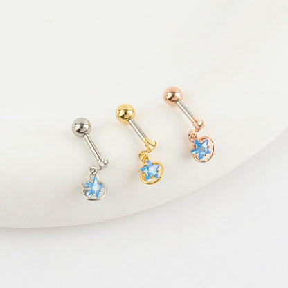 Trio of planet-themed barbell earrings with blue cubic zirconia, displayed in silver, gold, and rose gold.