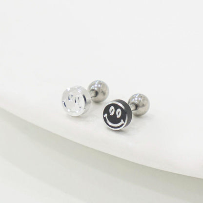 Silver and black smiley face stud earrings on white background