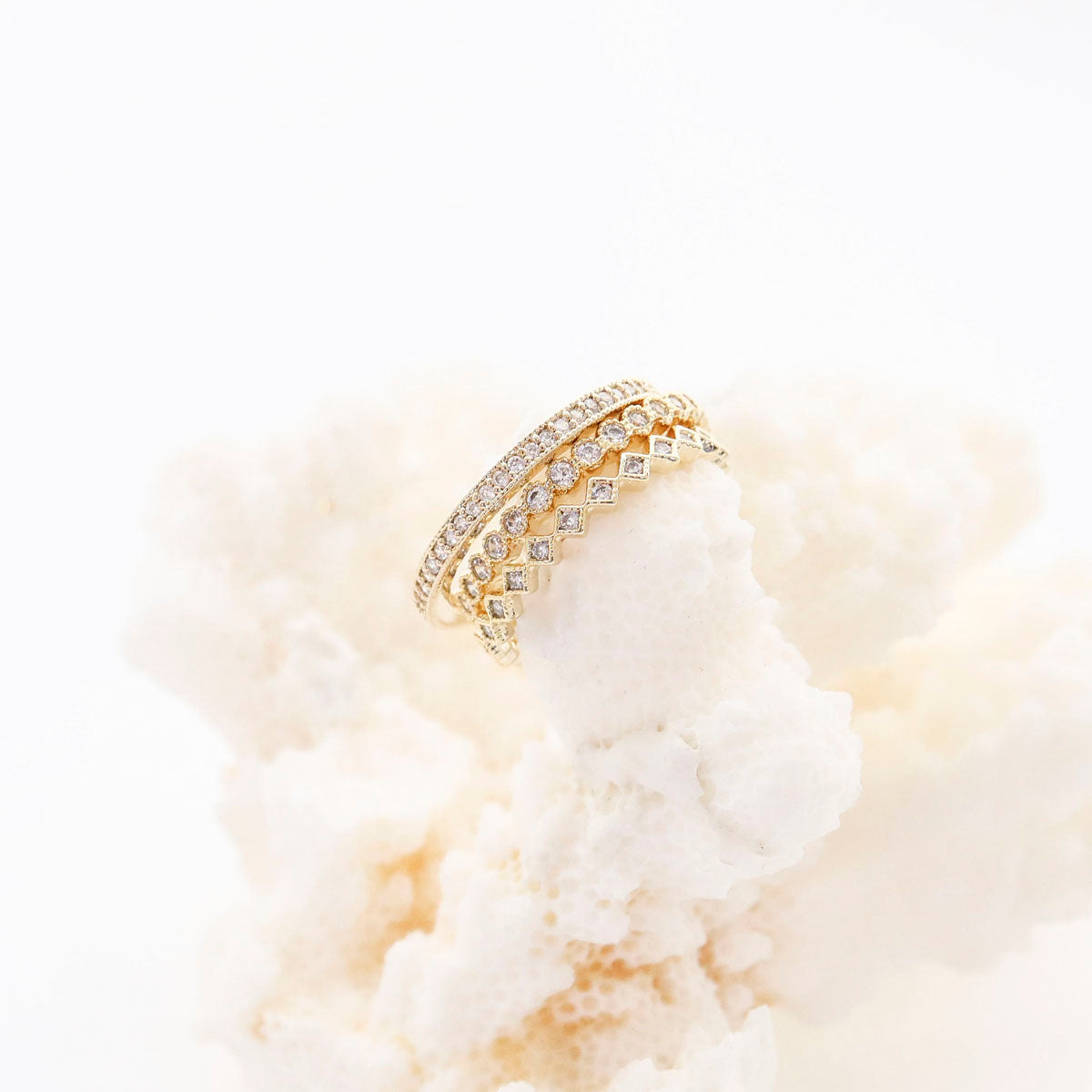 3-piece CZ stacking ring set on white flowers