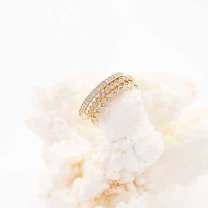 3-piece CZ stacking ring set on white flowers