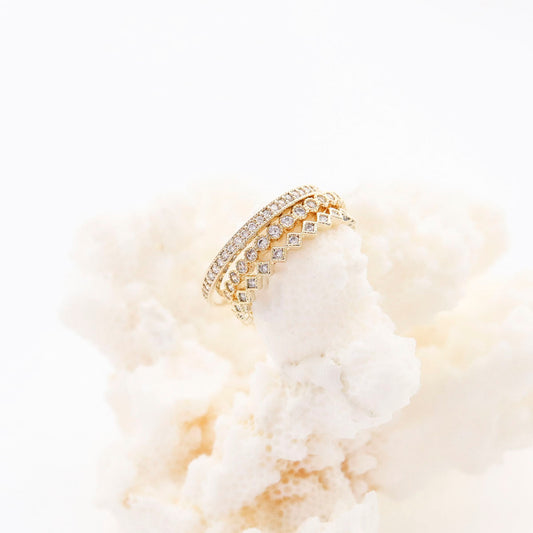 3-piece CZ stacking ring set on white flowers