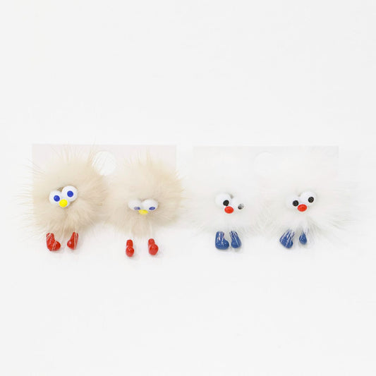 Beige fluffy character earring with googly eyes and red feet on a clean white background.