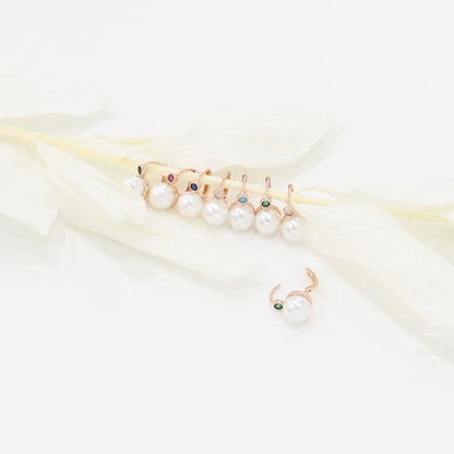 Assortment of colorful pearl drop earrings lined up on a white feather branch, showing 8 color options.