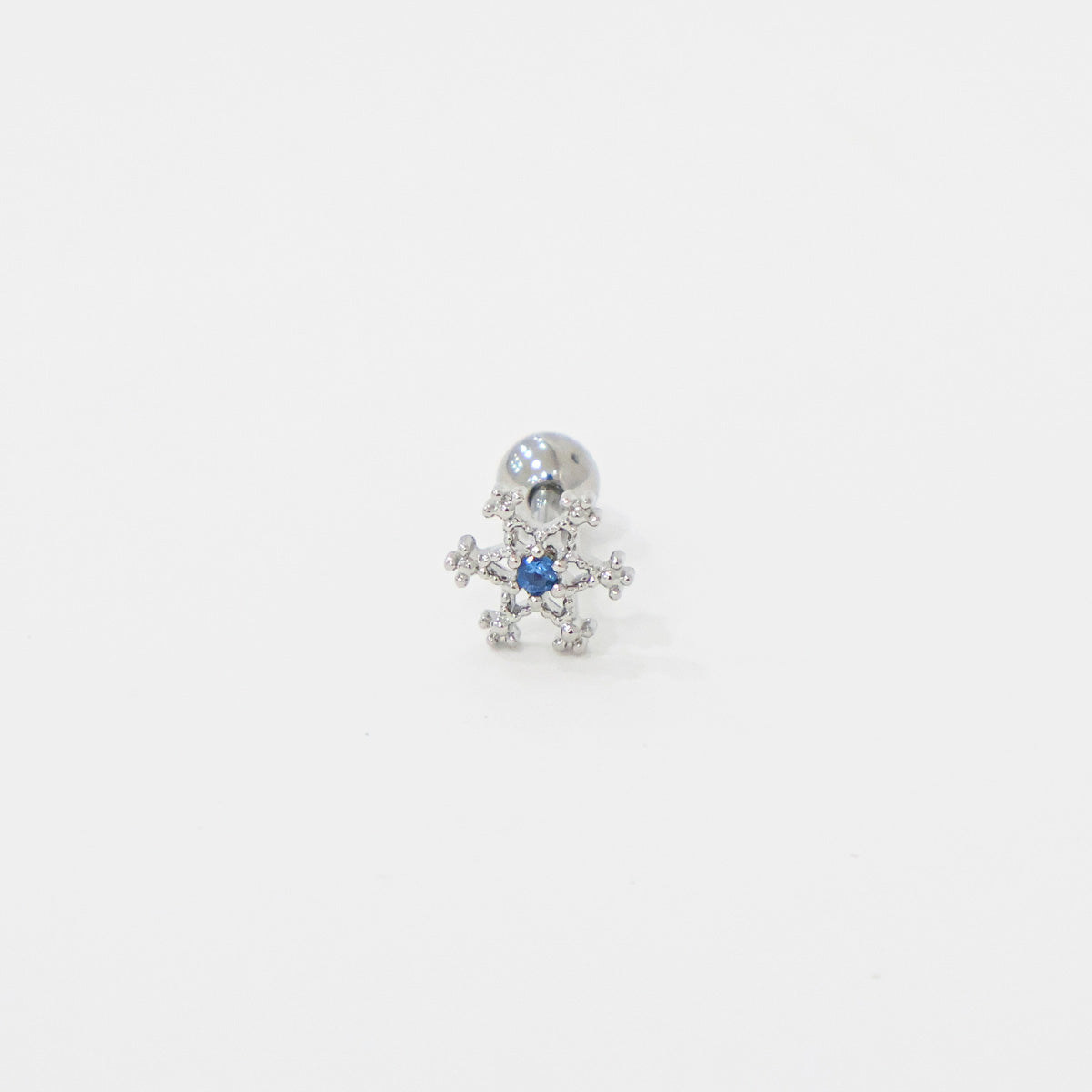 Single snowflake-shaped barbell piercing with blue cubic zirconia center, shown on white background.