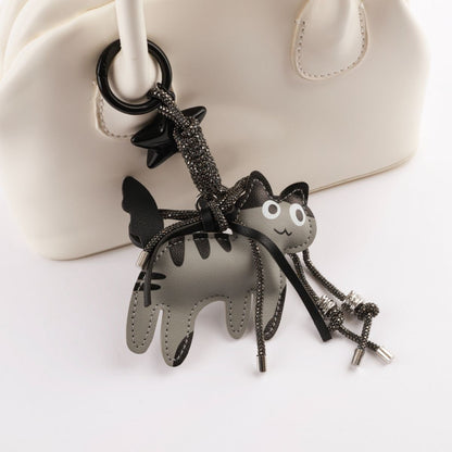 Grey leather cat keychain detail shot showing layered construction and black star charm