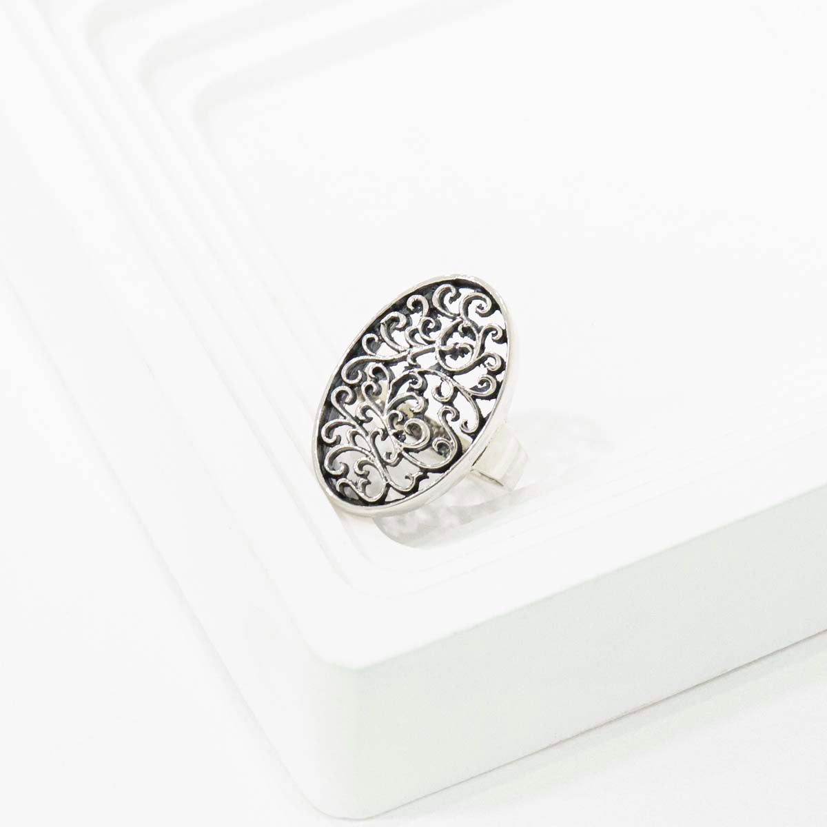 Detail shot of filigree openwork pattern with light passing through vine motifs