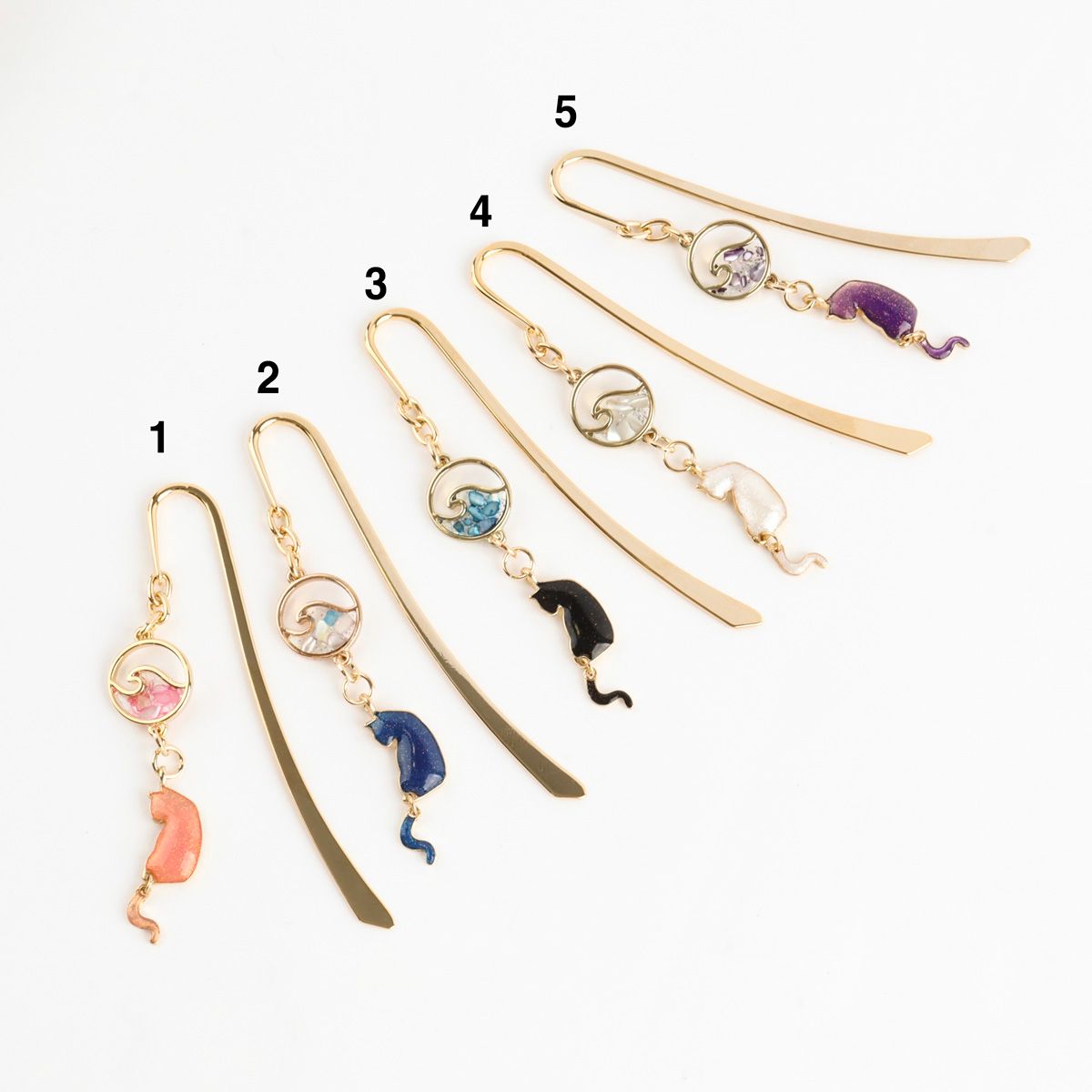 Five handmade cat wave metal bookmarks numbered 1-5 showing pink blue black white purple color options