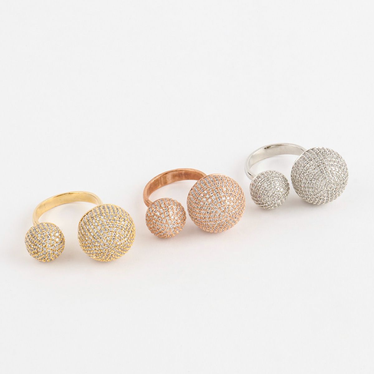 Set of three open rings with double crystal domes, lined up by color — gold, rose gold, and silver