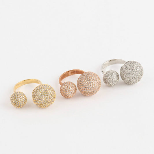 Set of three open rings with double crystal domes, lined up by color — gold, rose gold, and silver