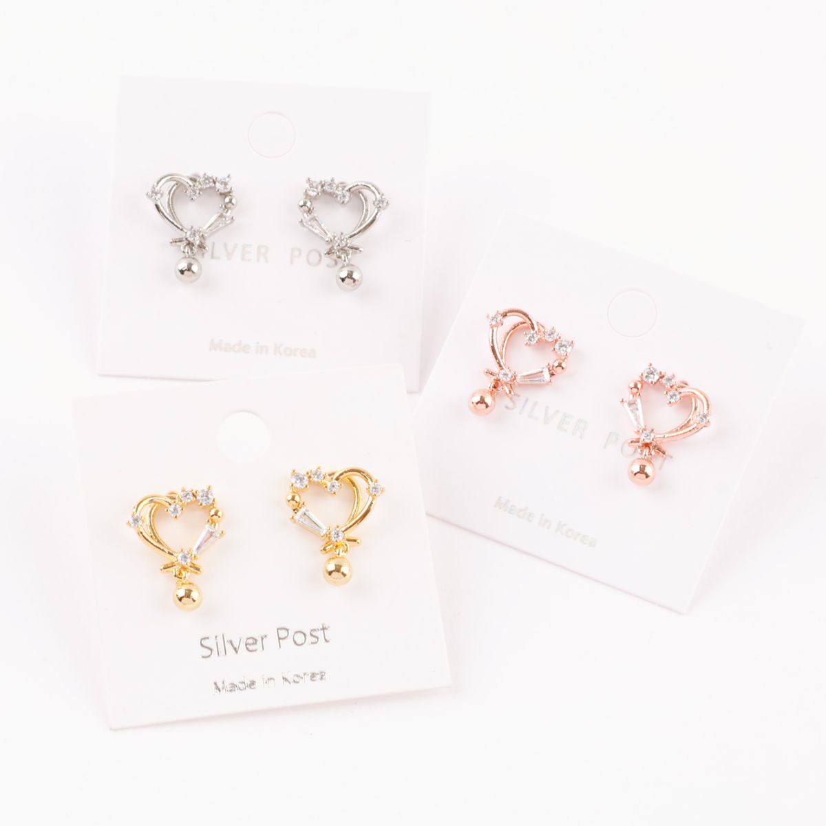 Three pairs of heart drop earrings on white cards, gold silver rose gold options, CZ crystal heart design with ball drops, 925 silver posts hypoallergenic, Made in Korea label, Korean handmade jewelry set