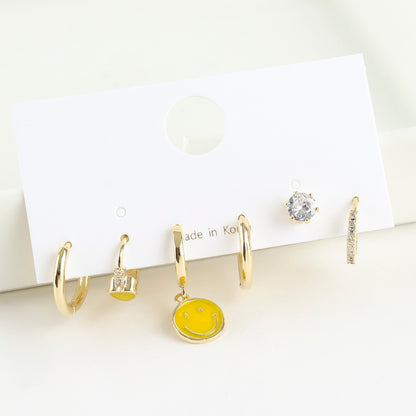 Smiley face hoop earring set with three asymmetric drop hoops on card