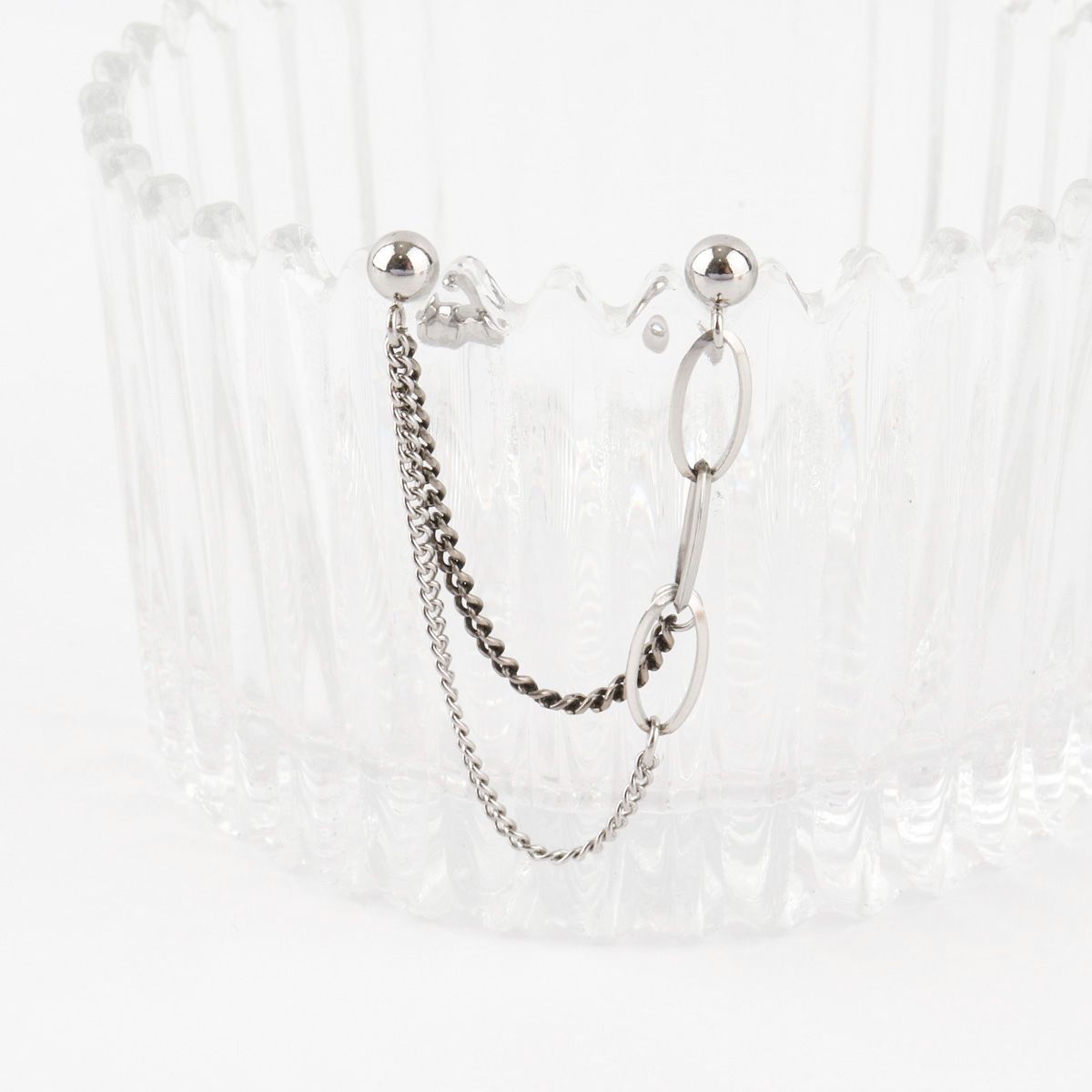 Surgical steel double barbell chain earrings with oval and curb chain links on white background