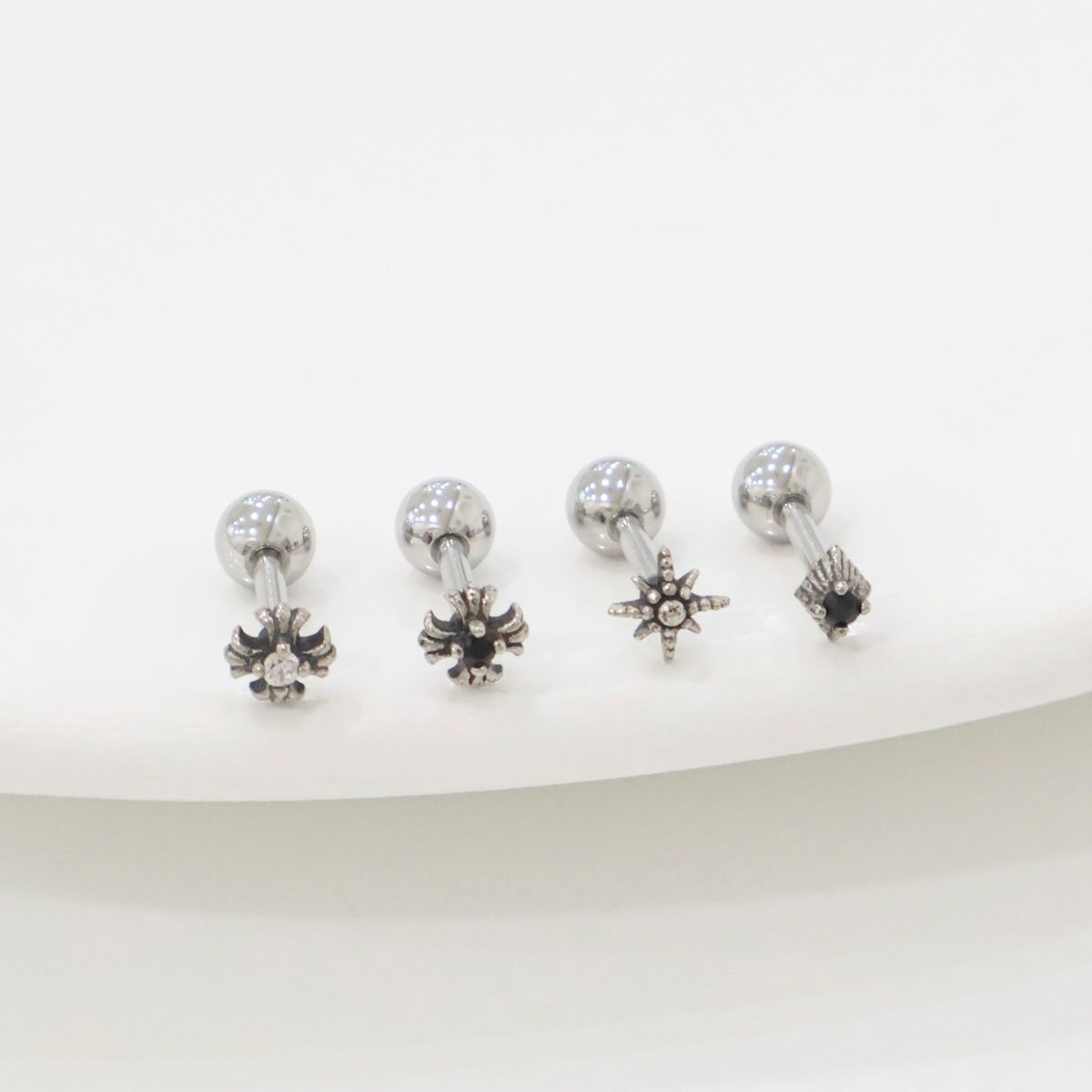 Size comparison image showing three star-themed barbell earrings beside a clear ruler. Focus on length and charm size for accurate product info.