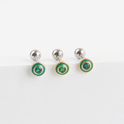 Green cubic barbell earrings displayed on white surface
