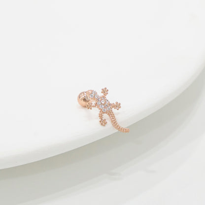 Rose gold lizard-shaped earring on a white background