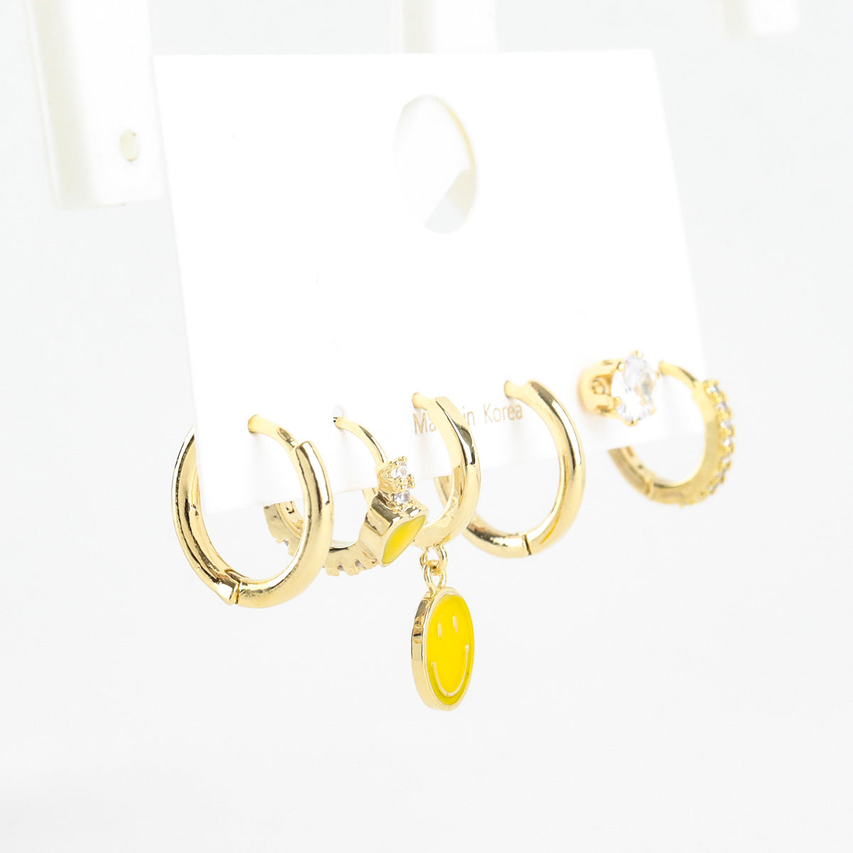 Three piece earring set with smiley heart and cubic charms