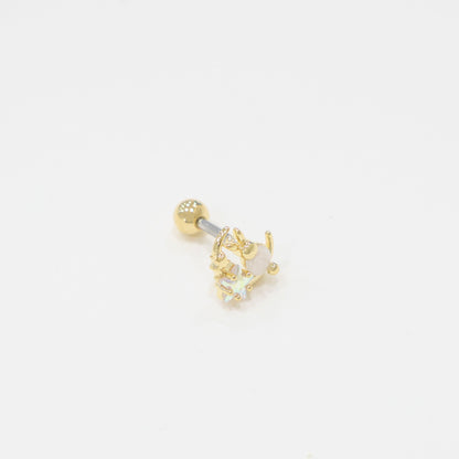 One gold bunny moon barbell earring photographed from a slight top-down angle, emphasizing the crystal details and metallic finish on a white background.