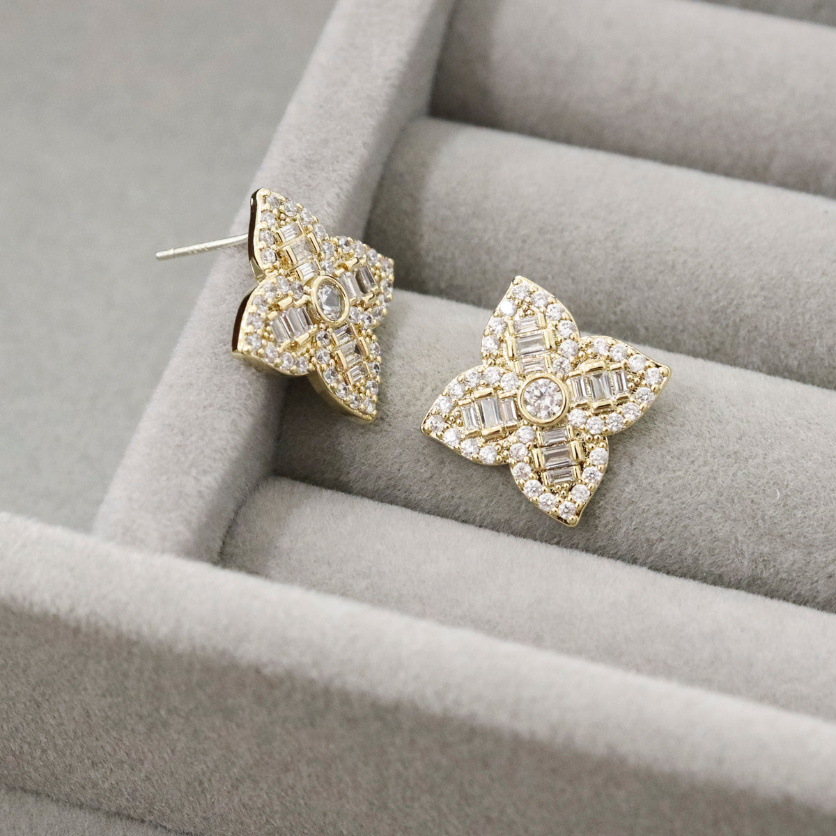 Gold floral cubic zirconia studs closeup showing 925 sterling silver post marking