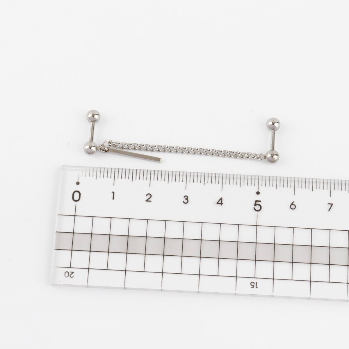 Size measurement of chain connected piercing showing 5-6cm chain length with ruler