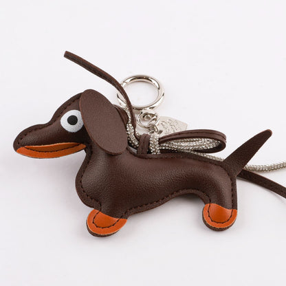 Brown leather Dachshund bag charm side view showing hand-stitched details and three-dimensional shape