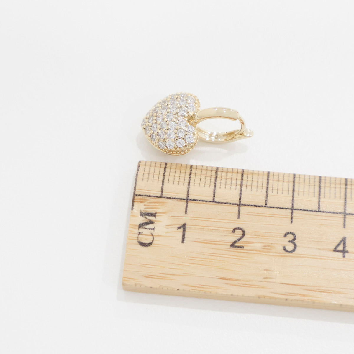 Size comparison of puffy heart earring next to ruler showing 2cm total length