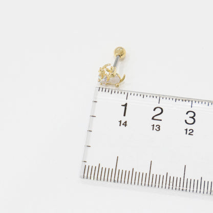 Close-up of a gold bunny moon earring placed beside a ruler, showing the size of the earring as approximately 1.5 cm.