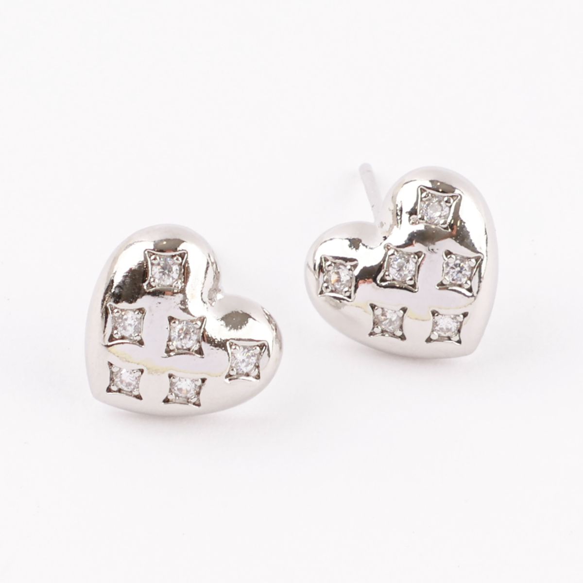 Detailed close-up of silver quilted heart earrings showing cubic zirconia rhinestone setting