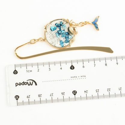 Whale tail metal bookmark with ruler showing 9cm total length measurement