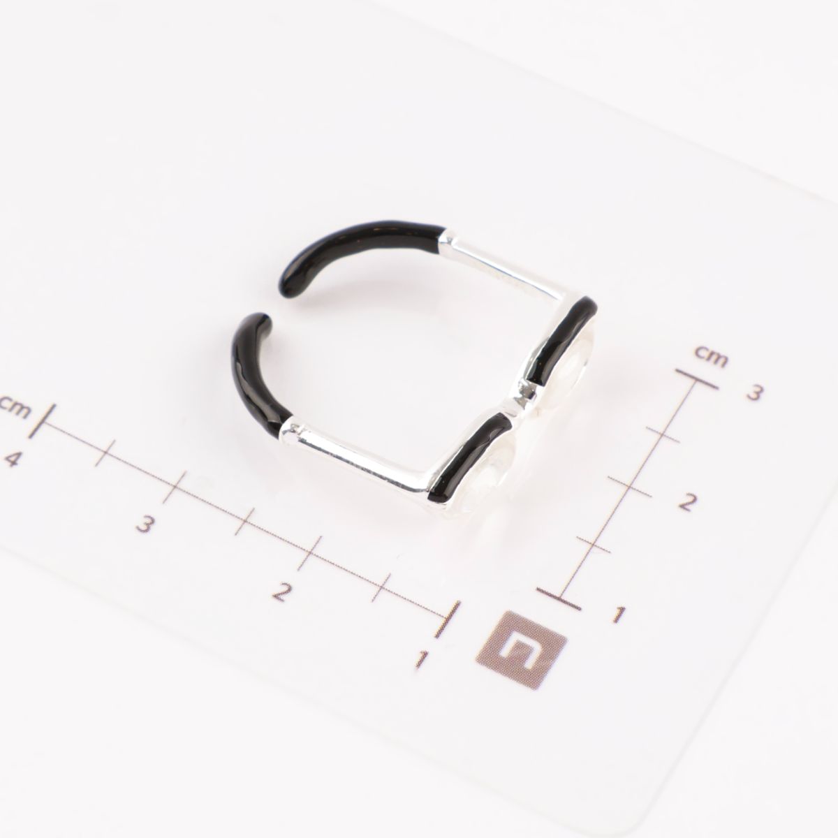 Size comparison of miniature glasses ring next to ruler showing 2.5cm width, adjustable open design visible