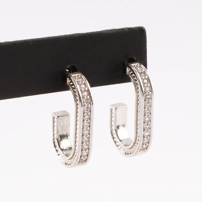 Silver oval drop stud earrings on black display stand