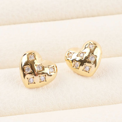 Gold chunky heart stud earrings with diamond quilted texture and sparkling rhinestones