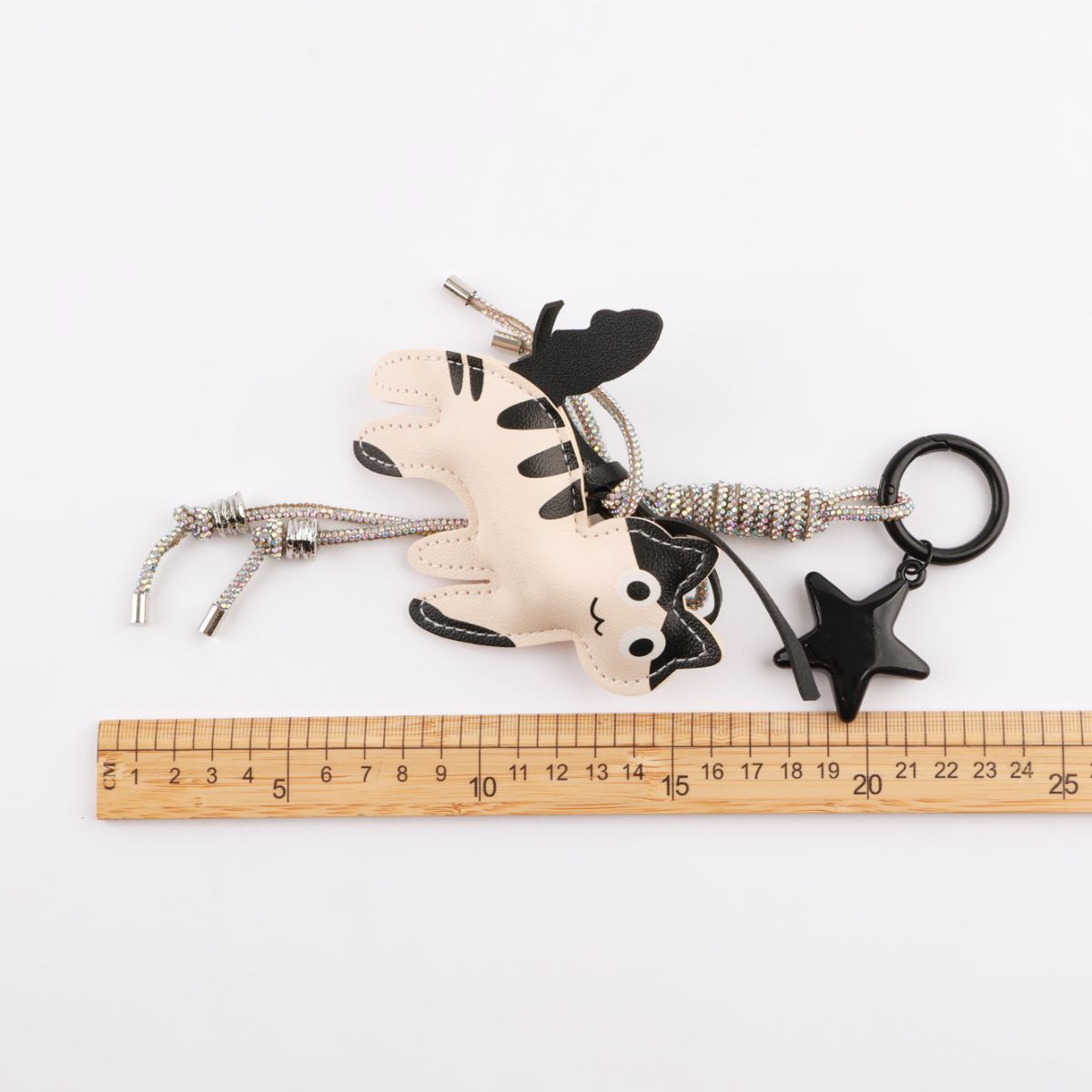 Size measurement of cream cat keychain approximately 18cm total length with ruler