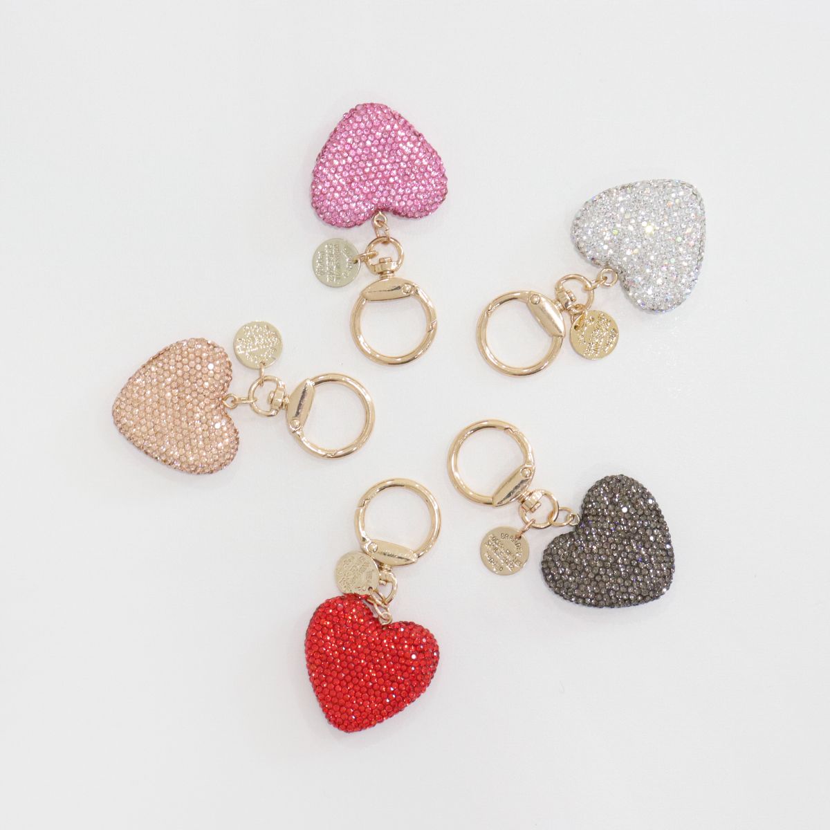 Five heart keychains arranged in a circular layout.
Colors include red, nude, black, pink, and white.