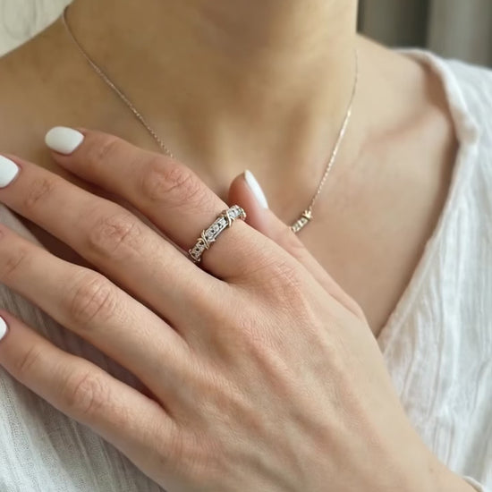 The 925 silver two-tone X-cross ring styled with a white linen blouse and a delicate necklace — showcasing everyday elegant styling