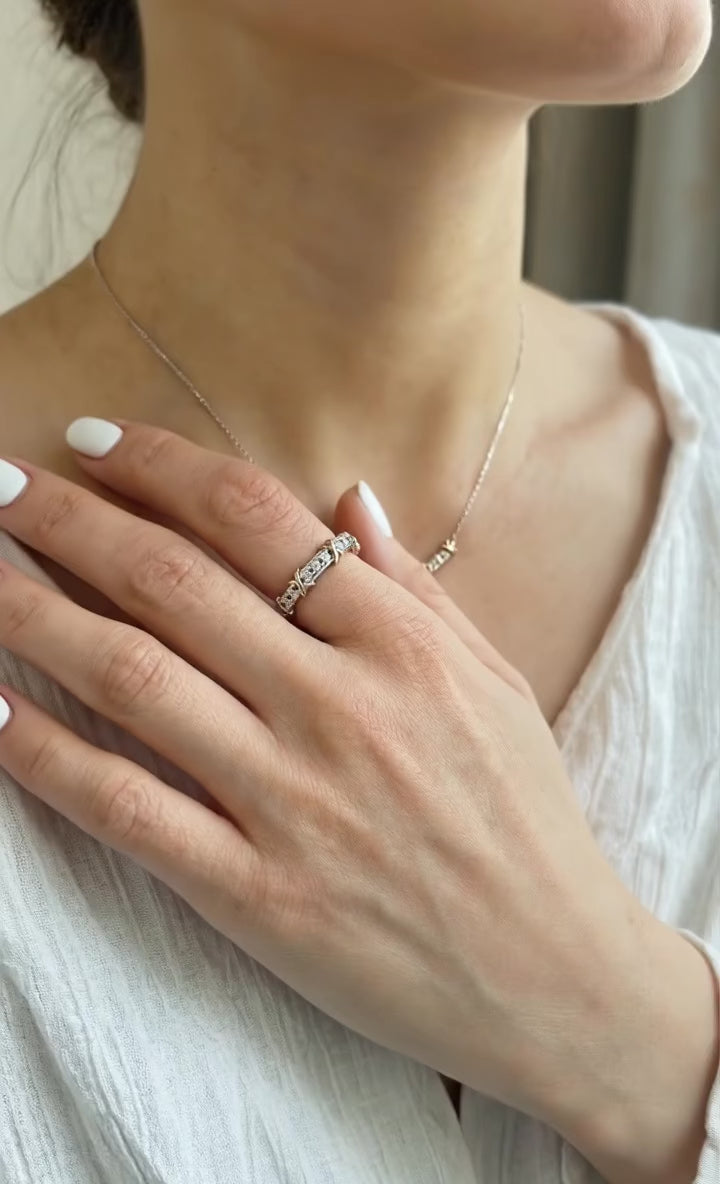 The 925 silver two-tone X-cross ring styled with a white linen blouse and a delicate necklace — showcasing everyday elegant styling