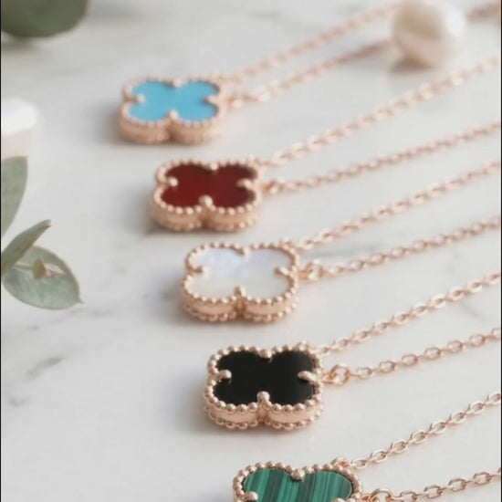 Rose gold clover gemstone necklace 5 color lineup 925 silver bezel-set pendant hypoallergenic K-style jewelry flat lay.